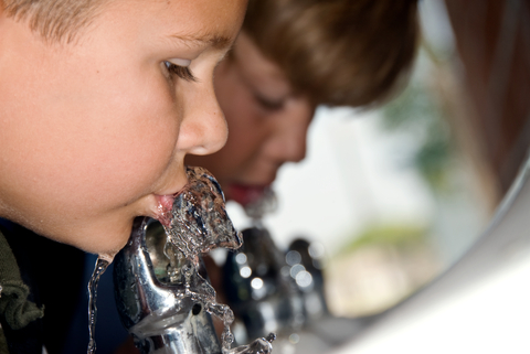 Children drinking from a water fountain