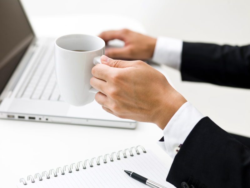 Office worker holding cup of coffee