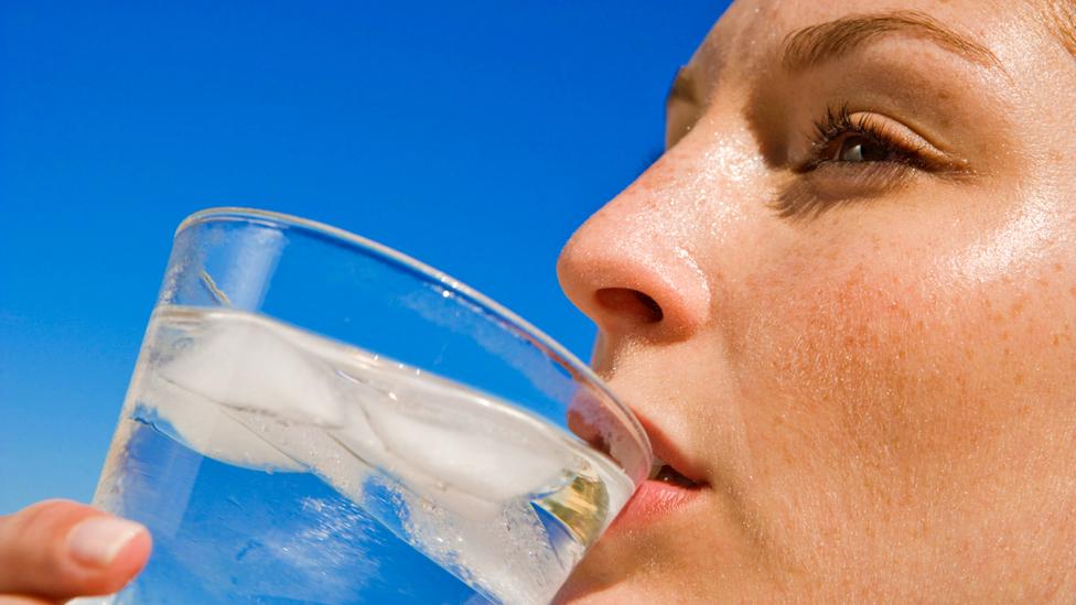 lady drinking glass water with ice